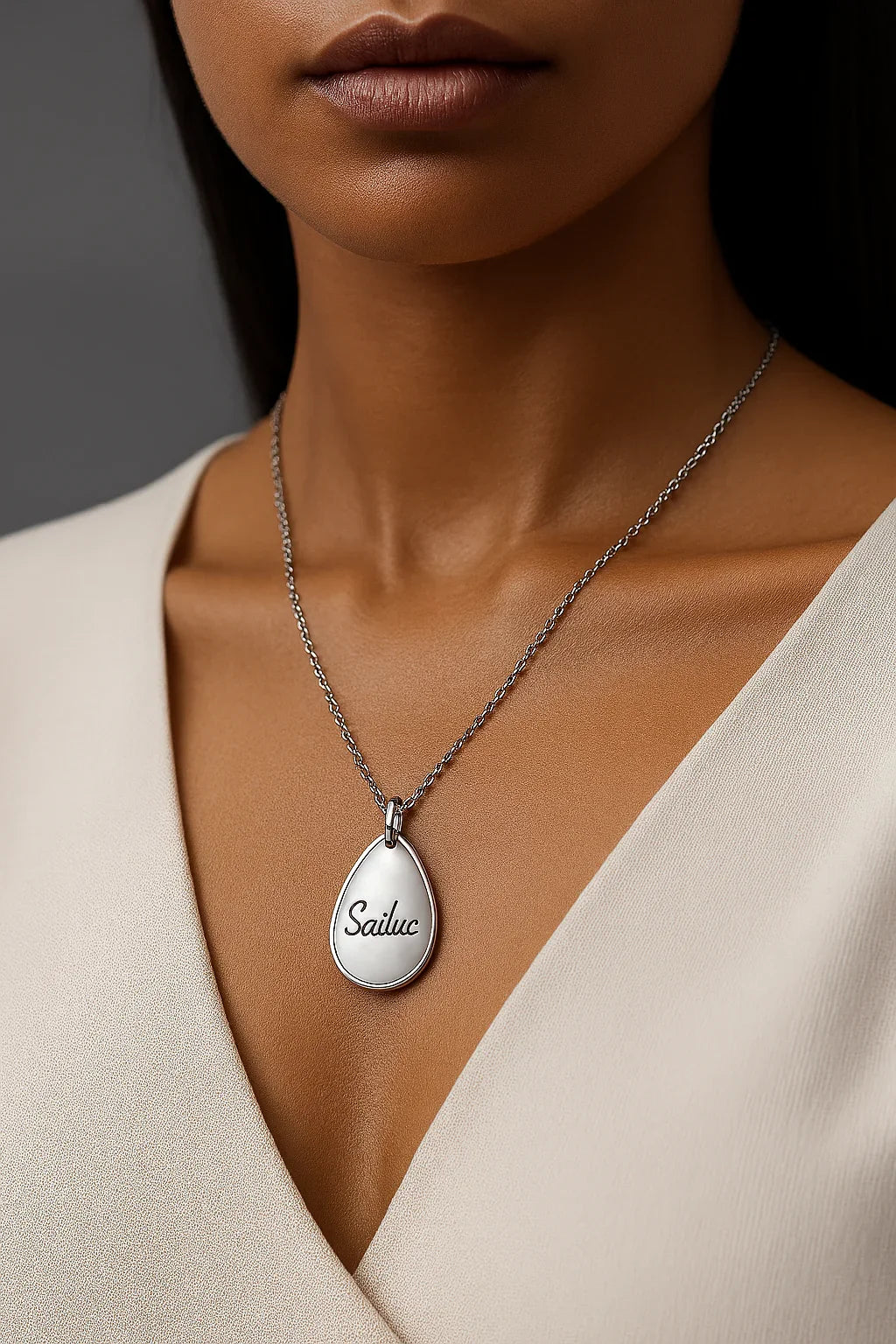 Woman wearing Sailuc luxury silver teardrop necklace, elegant fashion accessory