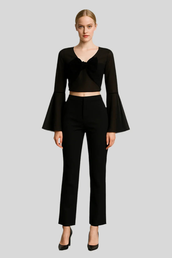 Woman in black luxury fashion set with flared sleeves and bow detail, Sailuc apparel