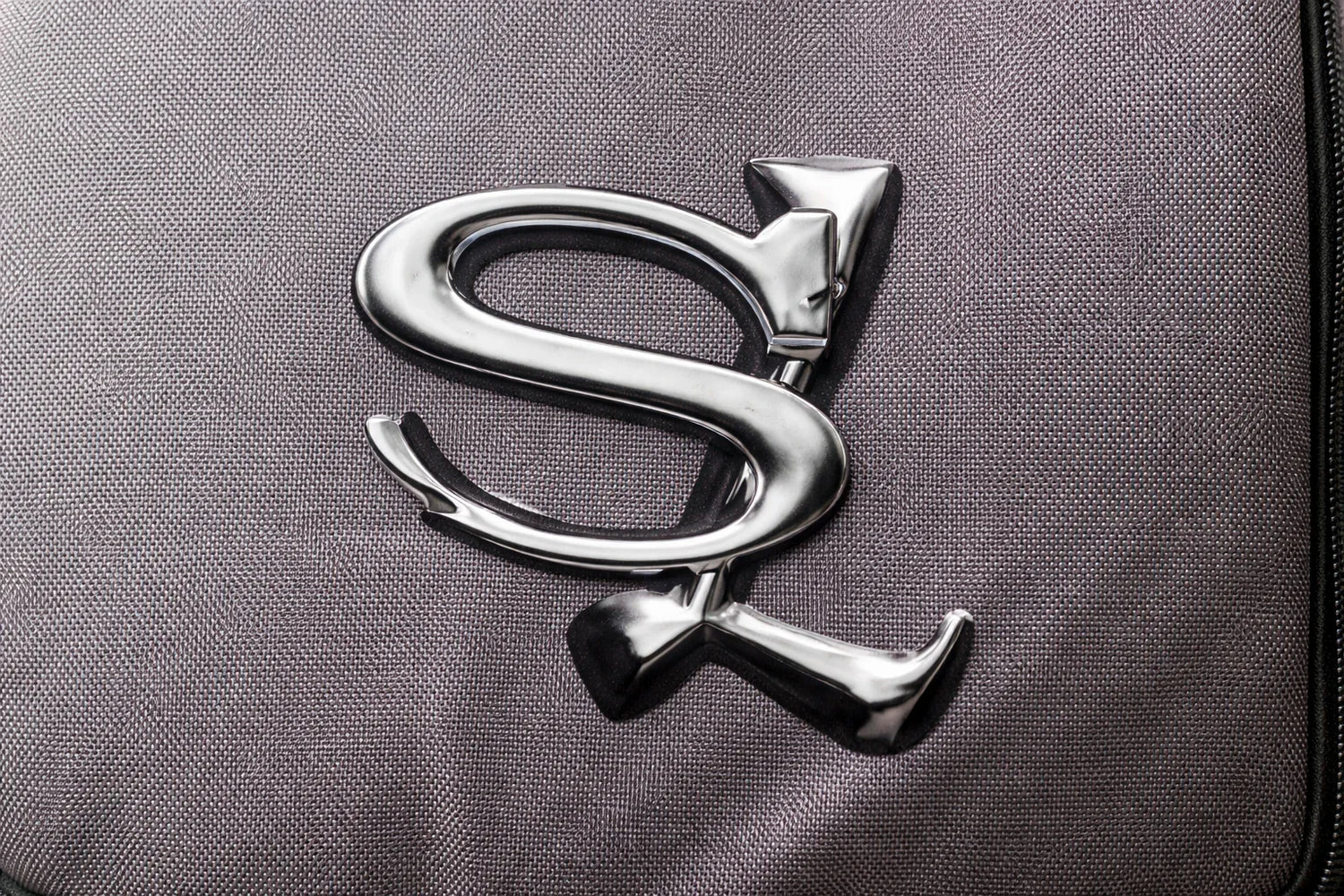 Sailuc metallic logo on textured gray luxury fabric