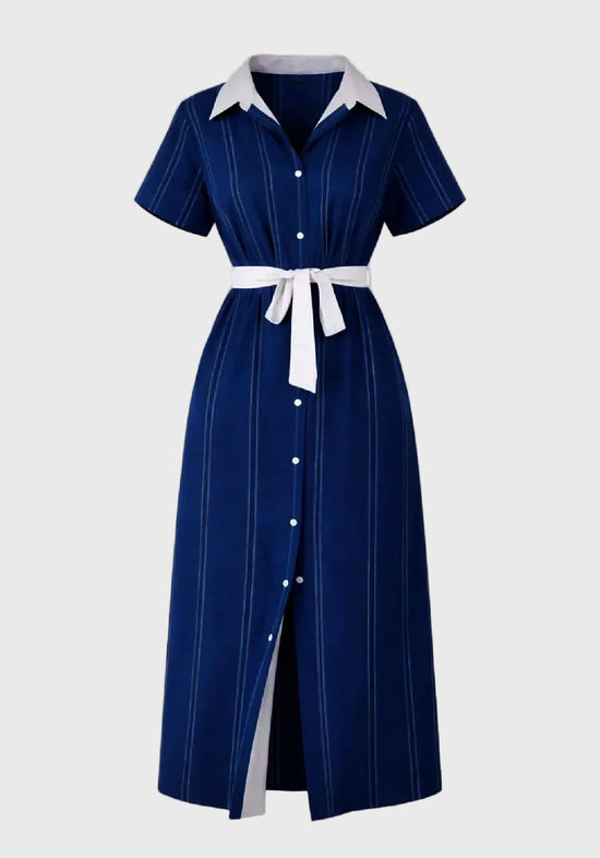 Navy dress with white collar and buttons on a gray background