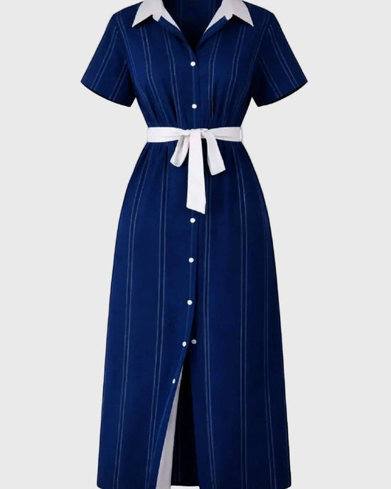 Navy dress with white collar and buttons on a gray background