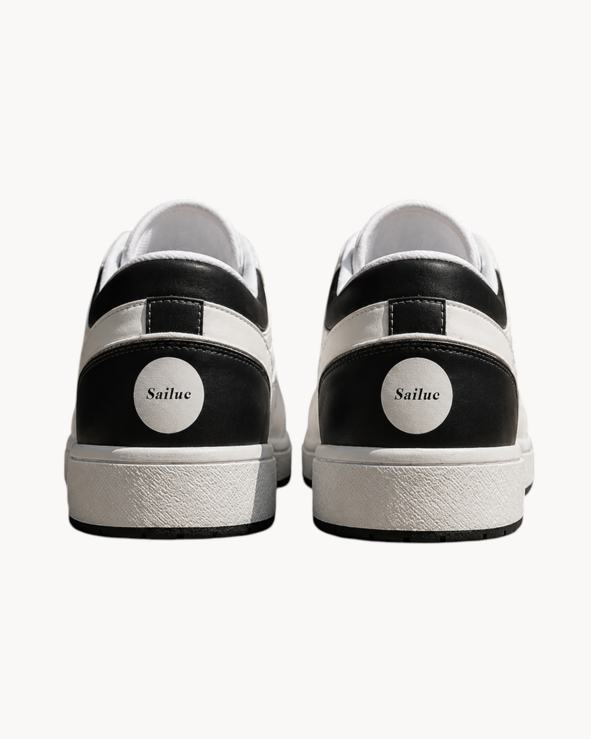 Rear view of Sailuc Low Form sneakers in black and white technical PU with a clean, minimal design and rubber soles.