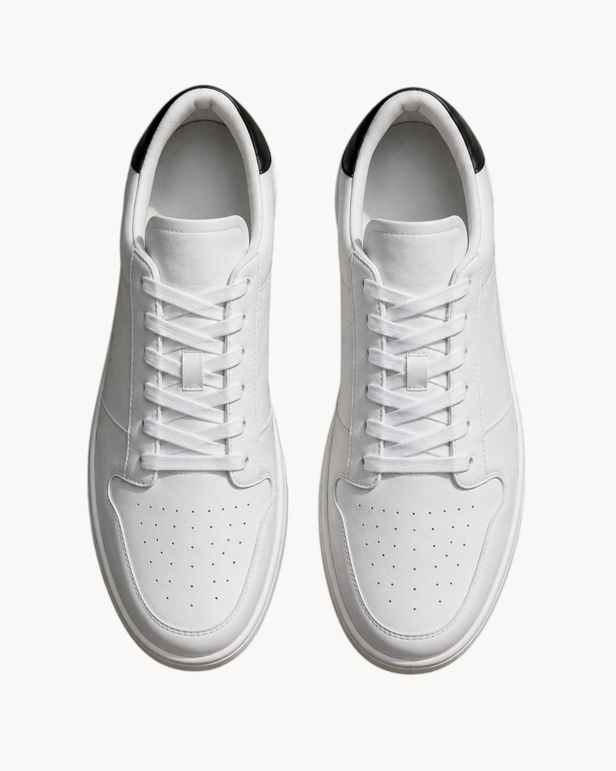 Sailuc Low Form sneakers in white technical PU with a minimal lace-up design and black heel detail, top view.
