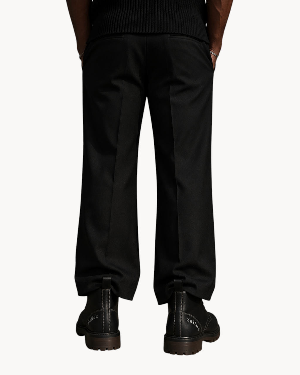 Sailuc Martin Rugged Style black combat boots with lace-up design and reinforced soles worn with black trousers