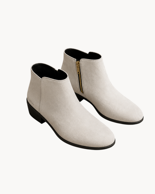 Sailuc ankle boots in off-white technical suede with a matte finish, gold side zipper, and a low block heel.