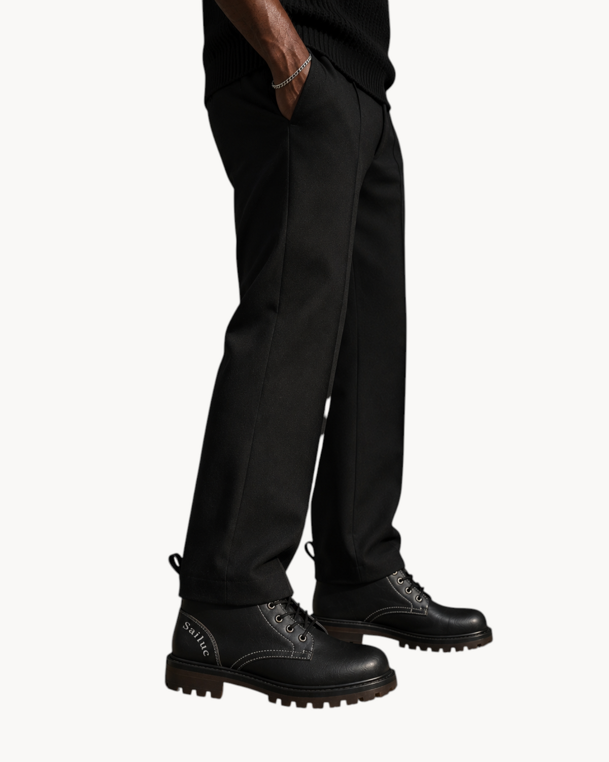 Sailuc Martin rugged style black combat boots with a lace-up design and reinforced sole worn by a man in black pants